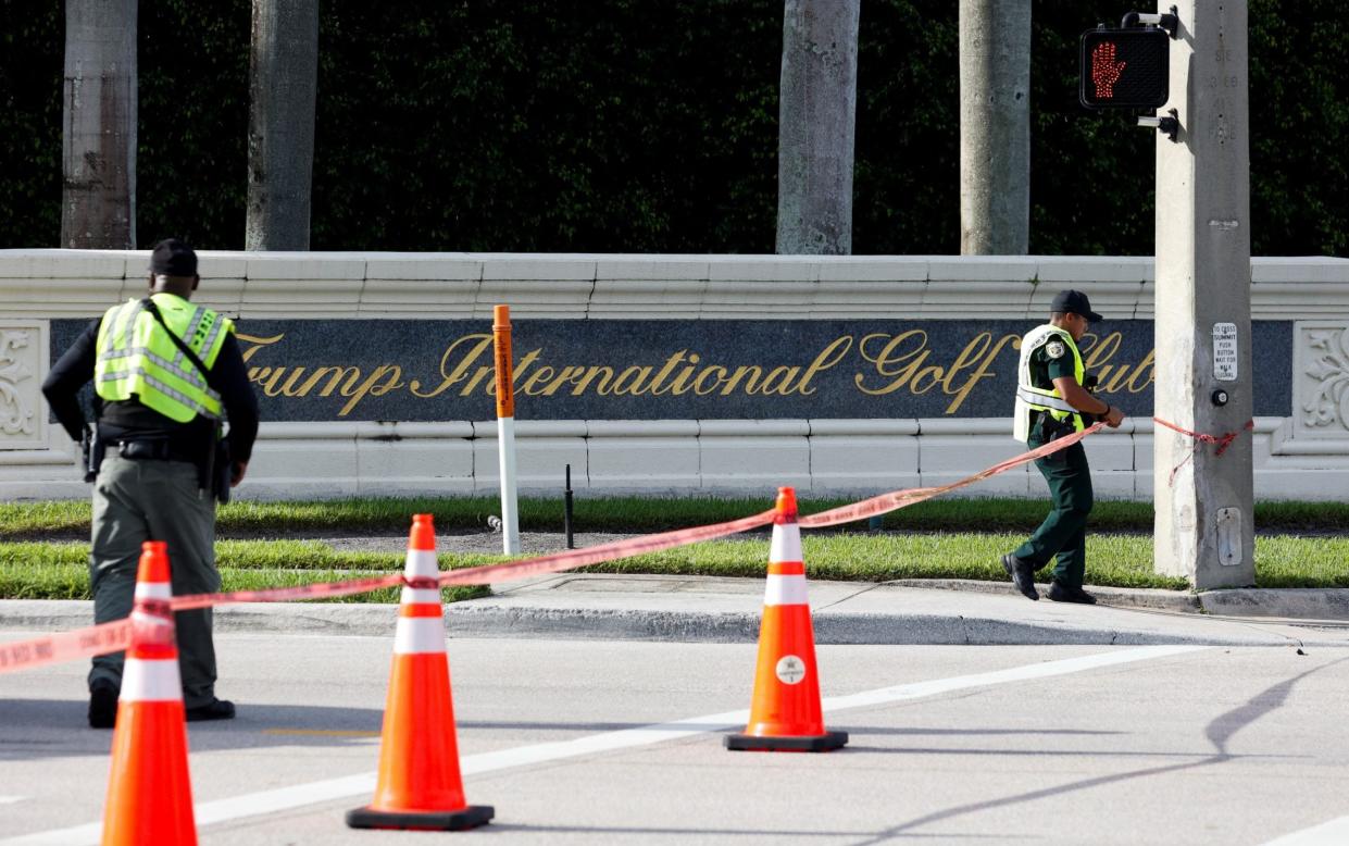 Officers cordoned off the road near the entrance of the golf course