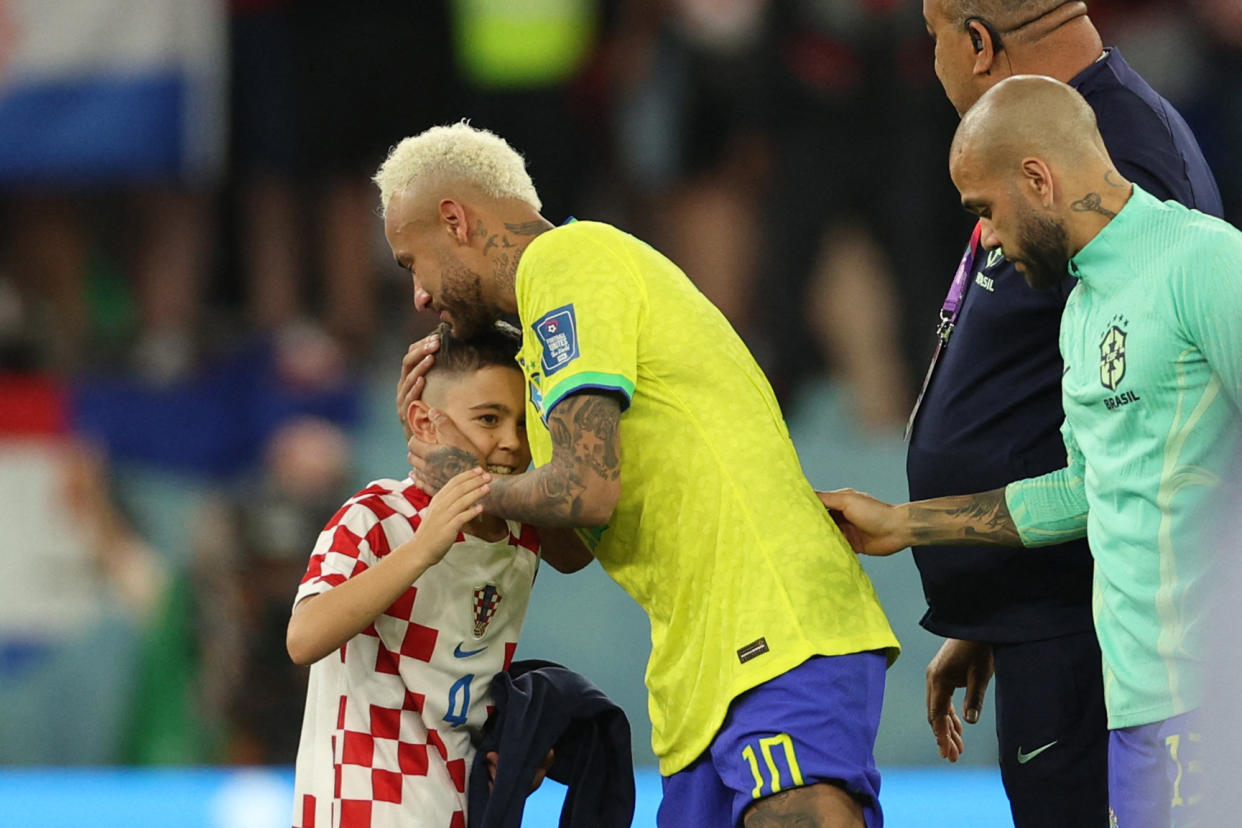 Brazil's forward #10 Neymar (C) is greeted by a Croatia supporter after his team lost the Qatar 2022 World Cup quarter-final football match between Croatia and Brazil at Education City Stadium in Al-Rayyan, west of Doha, on December 9, 2022. (Photo by Adrian DENNIS / AFP) (Photo by ADRIAN DENNIS/AFP via Getty Images)