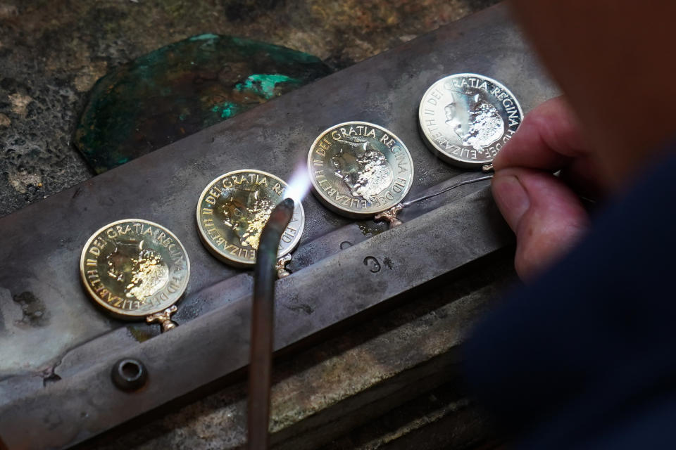 Rings to hold ribbons are soldered to Platinum Jubilee medals (Joe Giddens/PA)