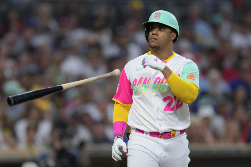 San Diego Padres' Juan Soto tosses his bat after drawing a walk during the third inning of a baseball game against the Texas Rangers, Friday, July 28, 2023, in San Diego. (AP Photo/Gregory Bull)