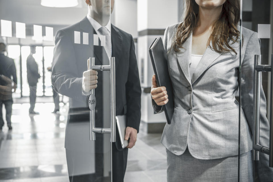 Colleagues leaving work together for break. (Getty Images)