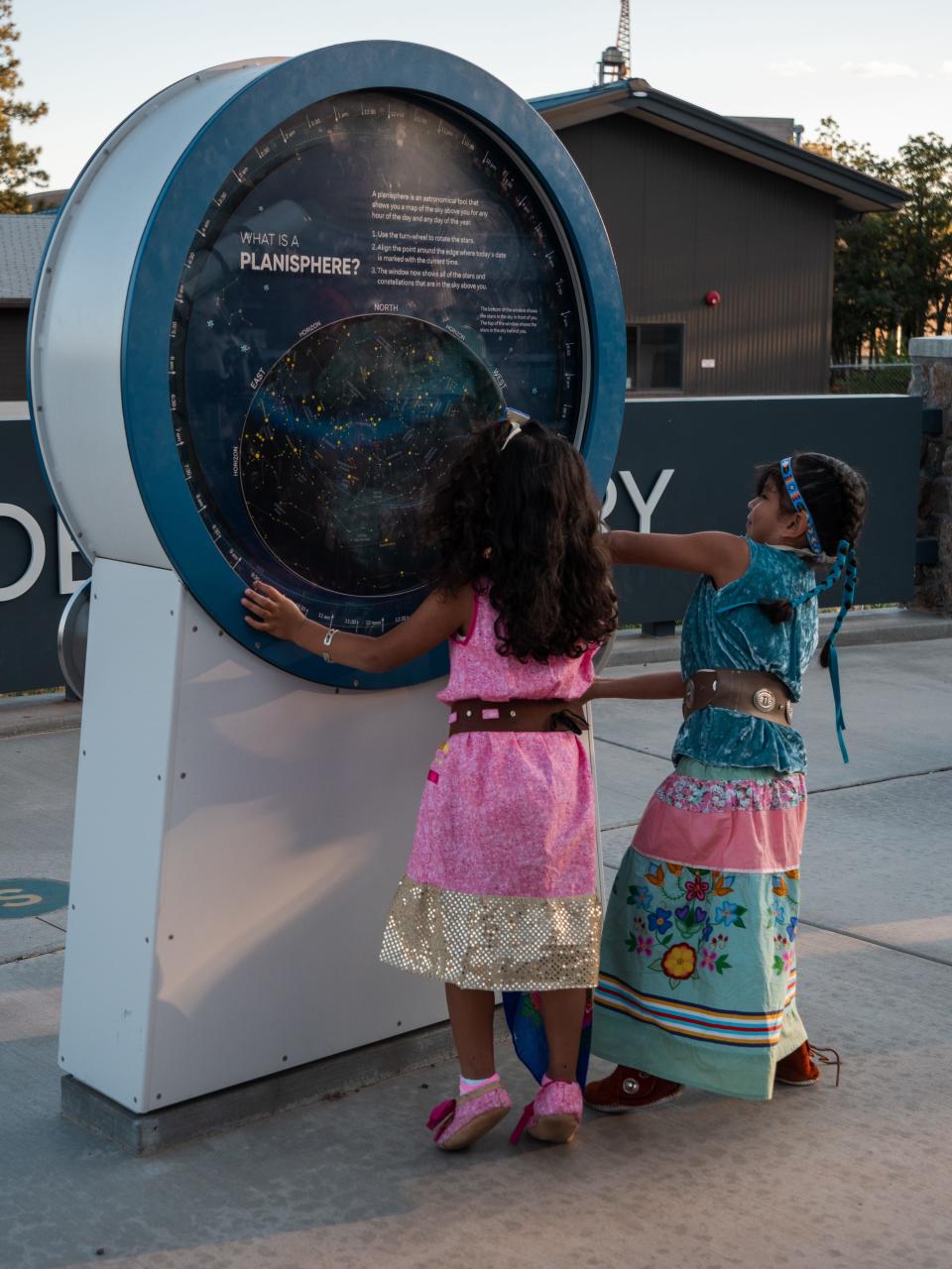 Native children examine one of Lowell Observatory's historic telescopes on July 13, 2023.