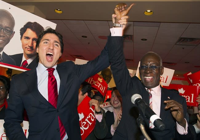 Liberal Leader Justin Trudeau, left, raises the arm of Emmanuel Dubourg in Montreal, Monday, November 25, 2013 following Dubourg's win in federal byelection for the riding of Bourassa. THE CANADIAN PRESS/Graham Hughes