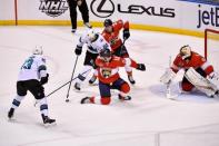 Jan 21, 2019; Sunrise, FL, USA; San Jose Sharks center Lukas Radil (52) controls the puck around Florida Panthers defenseman Ian McCoshen (12) during the third period at BB&T Center. Mandatory Credit: Jasen Vinlove-USA TODAY Sports