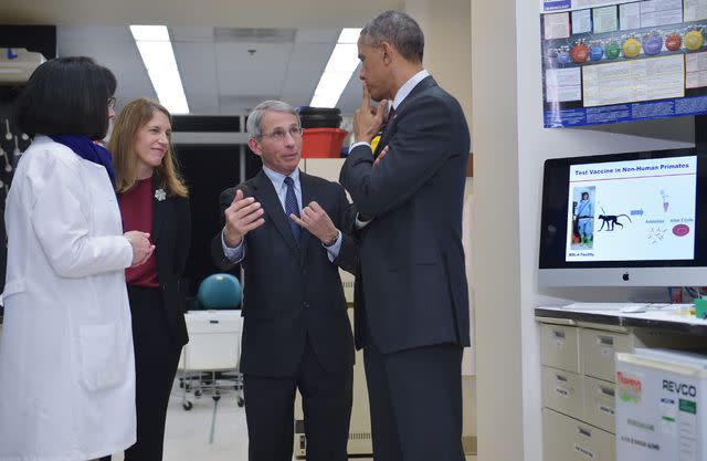 Mandel Ngan/Getty Dr. Fauci speaks to U.S. President Barack Obama during a tour of the vaccine research center at the National Institutes of Health in 2014