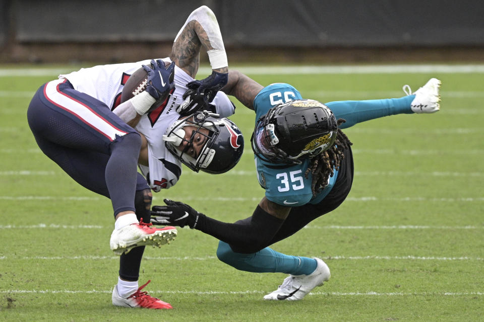 Houston Texans wide receiver Will Fuller V, left, is tackled by Jacksonville Jaguars cornerback Luq Barcoo (36) after a reception during the second half of an NFL football game, Sunday, Nov. 8, 2020, in Jacksonville, Fla. (AP Photo/Phelan M. Ebenhack)