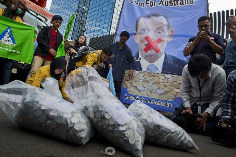 Indonesian demonstrators prepare bags of coins to be handed to the Australian embassy during a protest in Jakarta, on March 10, 2015