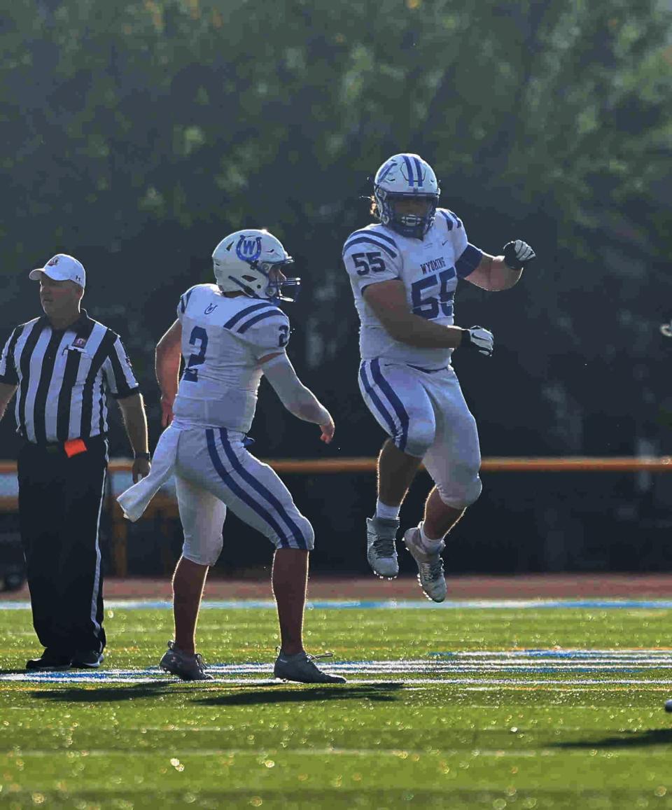 Wyoming defenders Quaid Hauer (2) and  Joel Allen celebrate after a sack during the football game between Taft and Wyoming high schools  Friday, Aug. 26, 2022.