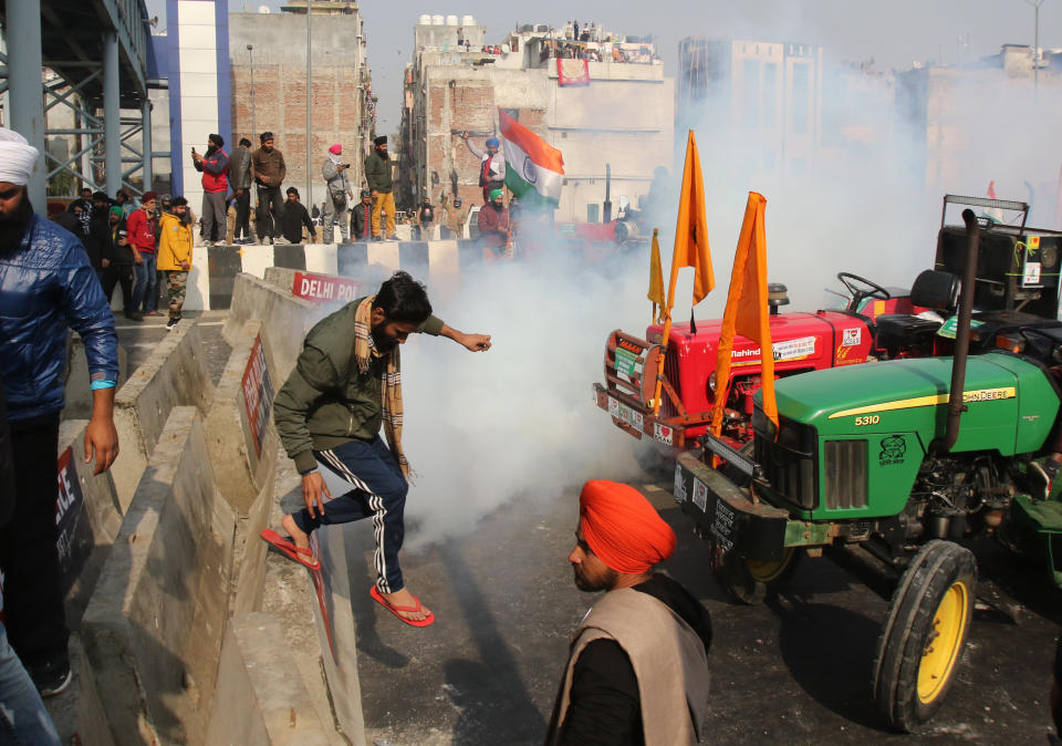 NOIDA, INDIA - JANUARY 26: Indian police use tear gas shell towards farmers during a rally as they continue their protest against the central government's recent agricultural reforms in Noida, India on January 26, 2021. (Photo by Pankaj Nangia/Anadolu Agency via Getty Images)