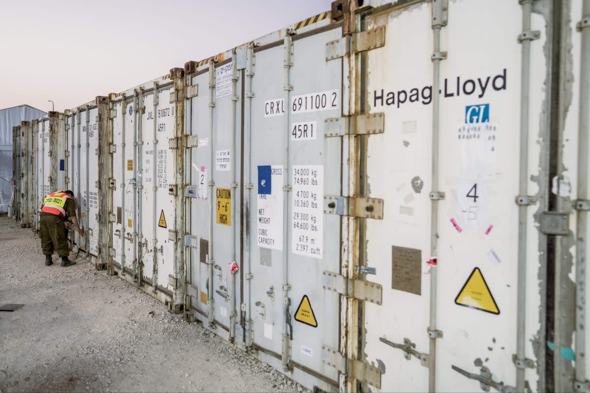 Scores of bodies are being kept in shipping containers waiting to be identified (Middle East Images/AFP via Getty)