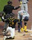 Milwaukee Brewers' Rhys Hoskins is awarded first base after being hit by a pitch from Pittsburgh Pirates relief pitcher Luis L. Ortiz, with bases loaded, forcing in a run during the third inning of a baseball game in Pittsburgh, Wednesday, April 24, 2024. (AP Photo/Gene J. Puskar)