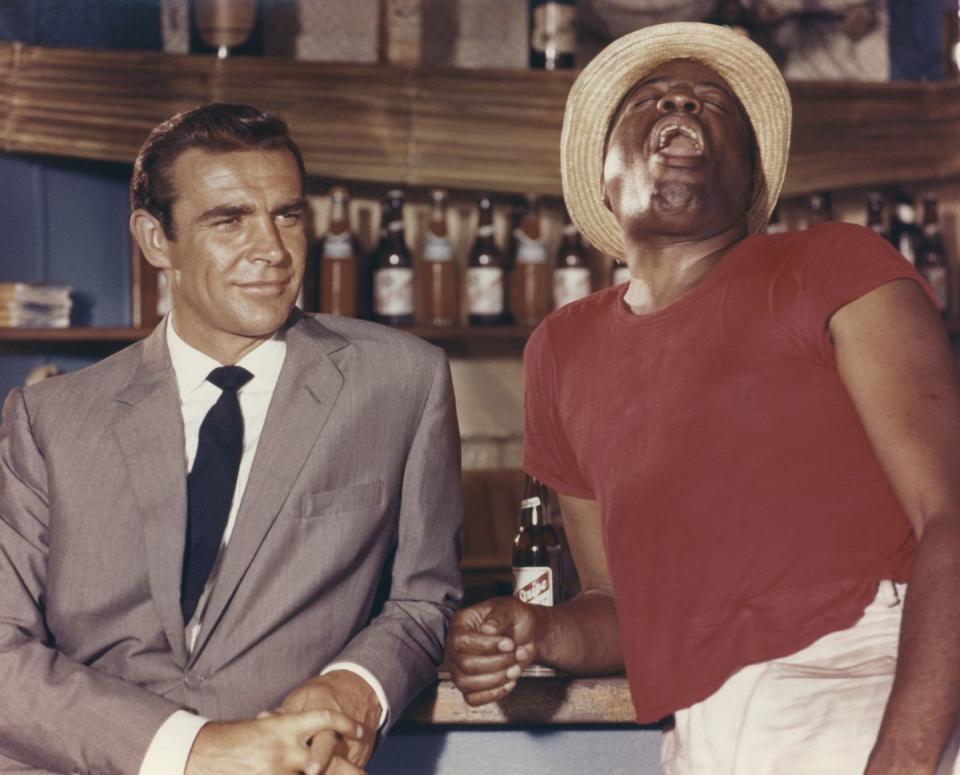 dr no 1962 sean connery as james bond 007 with john kitzmiller as quarrel standing by bar in the bahamas photo by screen archivesgetty images