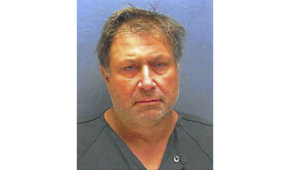 FILE - This Nov. 21, 2018, booking file photo provided by the Ocean Township Police Department shows Paul Caneiro. Authorities filed charges Thursday, Nov. 29, against Caneiro, the brother of a man whose body was found along with his wife and children after their New Jersey mansion was set on fire. (Ocean Township Police Department, File)