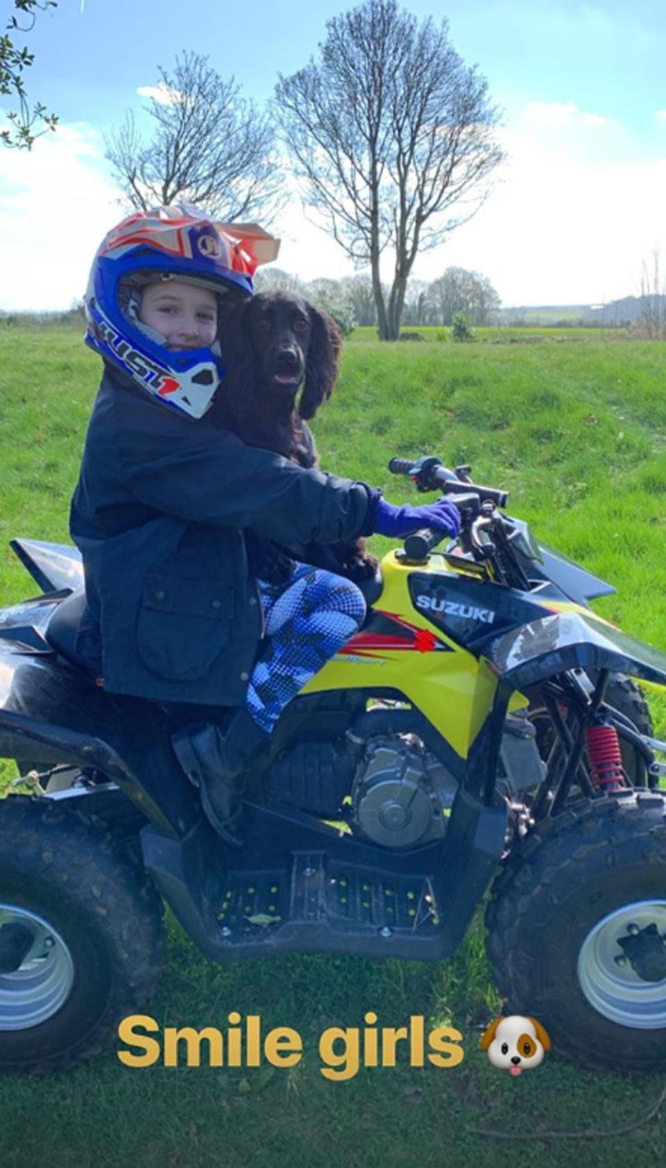 Smile: Harper and family dog Olive enjoyed a quad biking ride (Instagram / David Beckham)