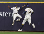 Milwaukee Brewers center fielder Lorenzo Cain leaps to catch a ball off the bat of St. Louis Cardinals' Tommy Edman during the second inning of a baseball game Wednesday, Sept. 22, 2021, in Milwaukee. Two Cardinal players tagged and scored on the play. (AP Photo/Jeffrey Phelps)
