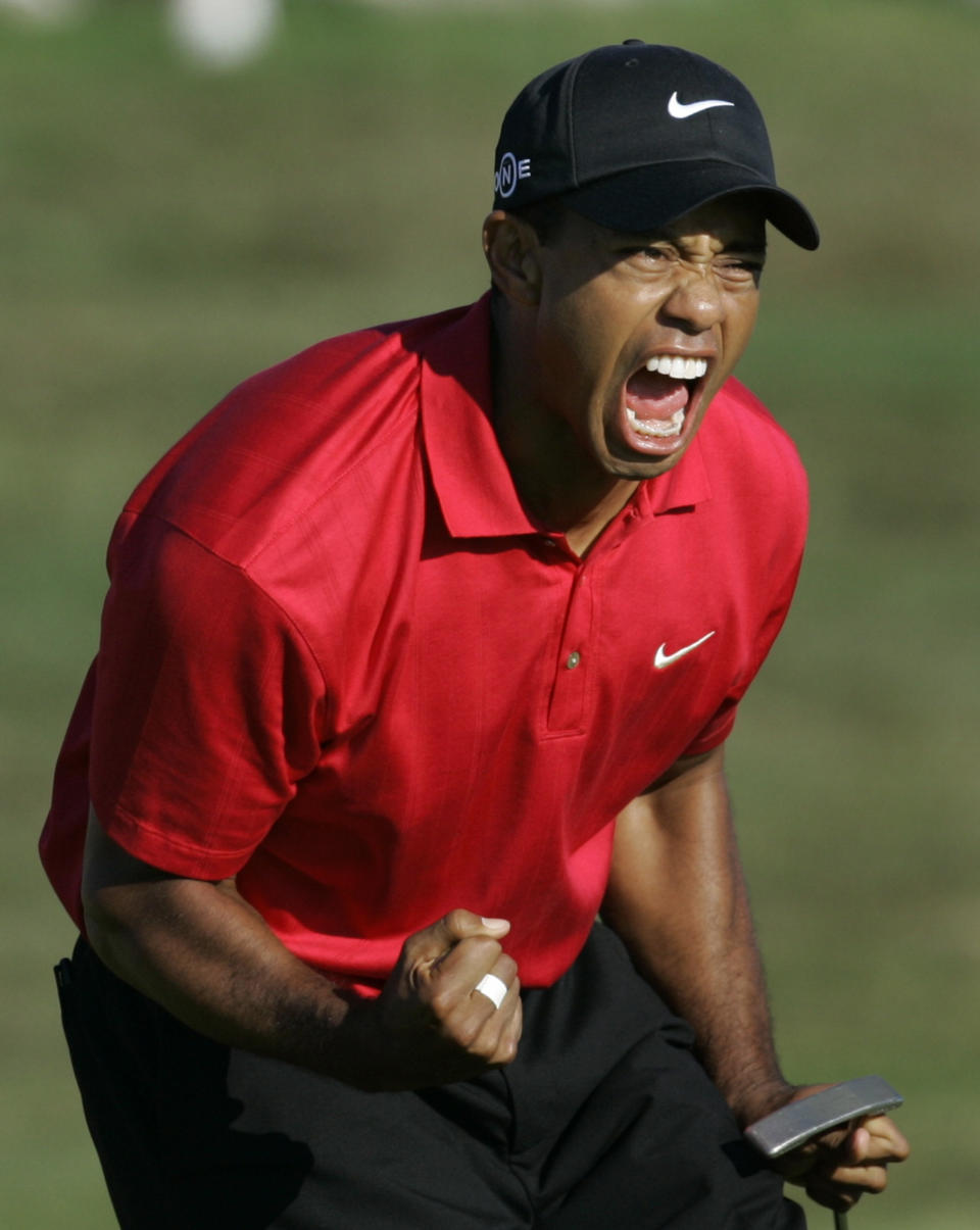 FILE - In this June 15, 2008, file photo taken by Lenny Ignelzi, Tiger Woods reacting after sinking a birdie putt on the 18th green, forcing a playoff against Rocco Mediate during the fourth round of the U.S. Open golf tournament at Torrey Pines in San Diego. Ignelzi, whose knack for being in the right place at the right time produced breathtaking images of Hall of Fame sports figures, life along the U.S.-Mexico border, devastating wildfires and numerous other major news events over nearly four decades as a photographer for The Associated Press in San Diego, has died. He was 74. (AP Photo/Lenny Ignelzi, File)