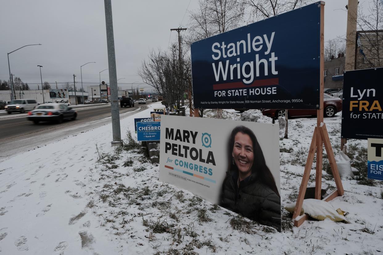 Campaign signs line a street corner in Anchorage