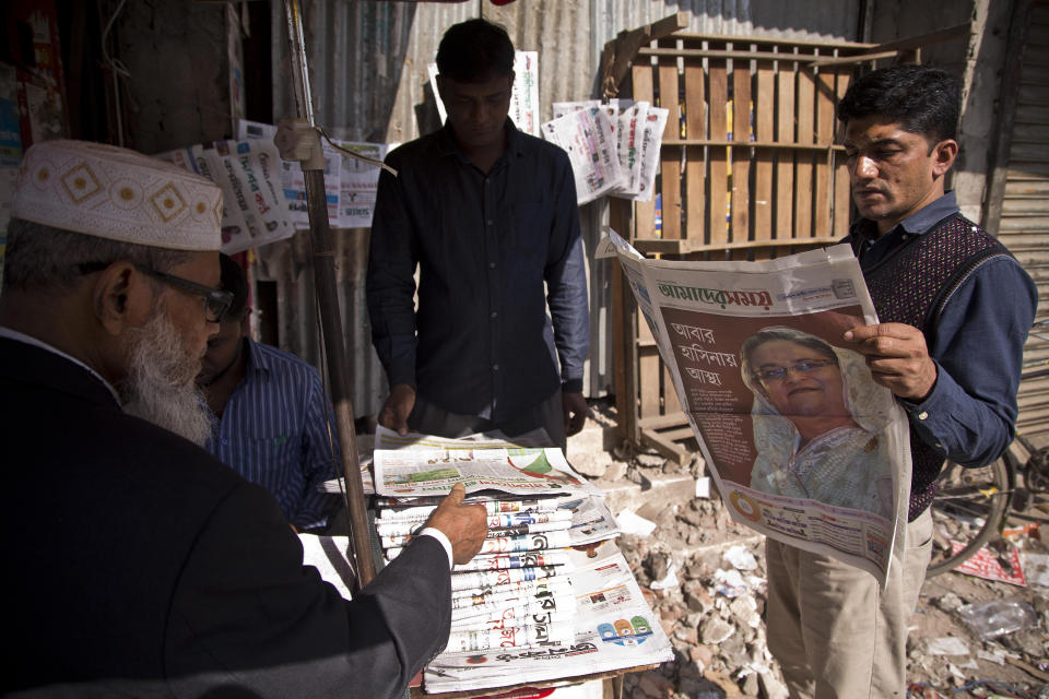 A Bangladeshi reads a newspaper showing a portrait of Prime Minister Sheikh Hasina a day after general elections in Dhaka, Bangladesh, Monday, Dec. 31, 2018. Bangladesh's ruling alliance won virtually every parliamentary seat in the country's general election, according to official results released Monday, giving Hasina a third straight term despite allegations of intimidation and the opposition disputing the outcome. (AP Photo/Anupam Nath)