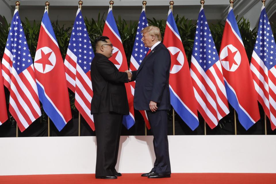 Donald Trump shakes hands with North Korea leader Kim Jong-un at historic summit (AP)