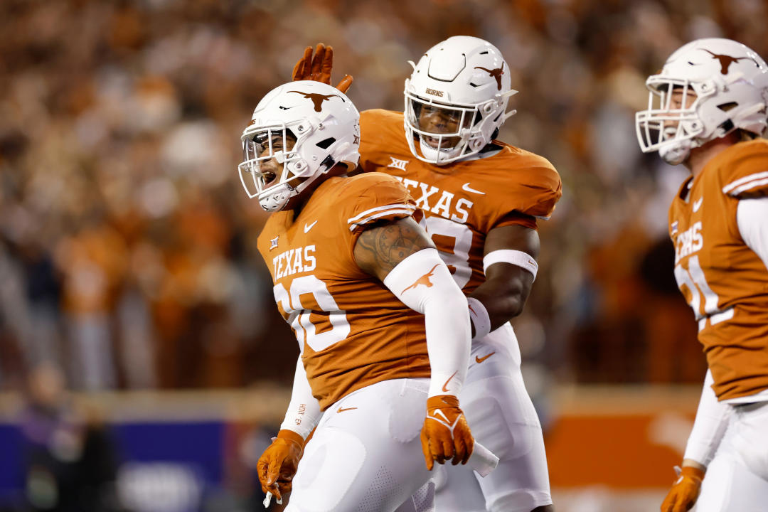 AUSTIN, TEXAS - NOVEMBER 12: Byron Murphy II #90 of the Texas Longhorns is congratulated by Barryn Sorrell #88 after a play on special teams in the first half against the TCU Horned Frogs at Darrell K Royal-Texas Memorial Stadium on November 12, 2022 in Austin, Texas. (Photo by Tim Warner/Getty Images)