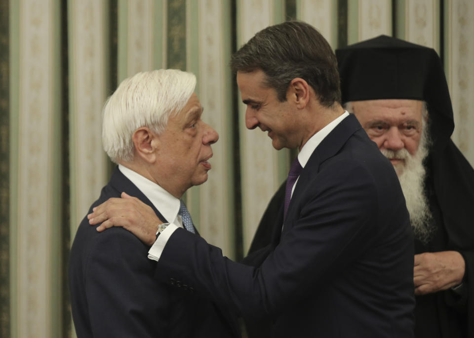 Greece's newly-letted prime minister Kyriakos Mitsotakis, right, talks with Greek President Prokopis Pavlopoulos, shortly after his swearing0-n ceremony at the Presidential Palace in Athens, Monday, July 8, 2019. Mitsotakis' New Democracy party won 39.8% of the vote, giving him 158 seats in the 300-member parliament, a comfortable governing majority. (AP Photo/Petros Giannakouris)