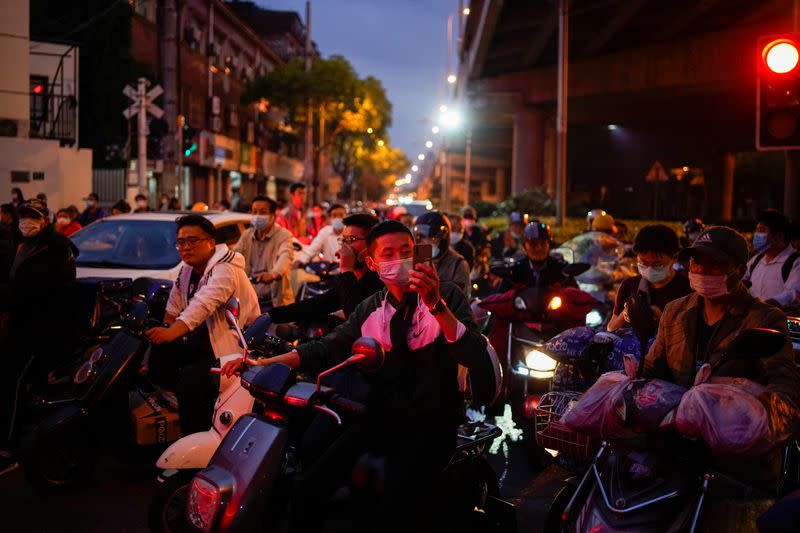 People wearing protective face masks are seen on a street, amid an outbreak of the coronavirus disease (COVID-19), in Shanghai