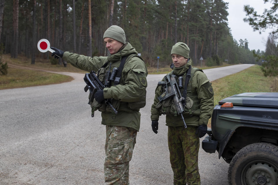 FILE - Lithuanian soldiers patrol a road near the Lithuania-Belarus border near the village of Jaskonys, Druskininkai district some 160 km (100 miles) south of the capital Vilnius, Lithuania, on Nov. 13, 2021. Lithuania decided Wednesday Feb. 21, 2024 to shut down two more of its six checkpoints with Belarus as of next month, amid growing tensions with its eastern neighbor, an ally of Russia, bringing the total of closed border crossings into the Baltic country to four. (AP Photo/Mindaugas Kulbis, File)