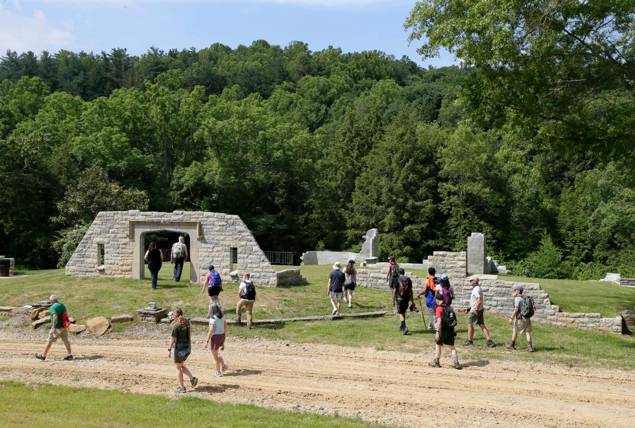 Members of the Friends of the Metro Parks explore the remains of the Benua House, a 4700-square-foot structure on previously private land, during a tour at Clear Creek Metro Park in Rockbridge, Ohio, on Sunday, June 6, 2021.