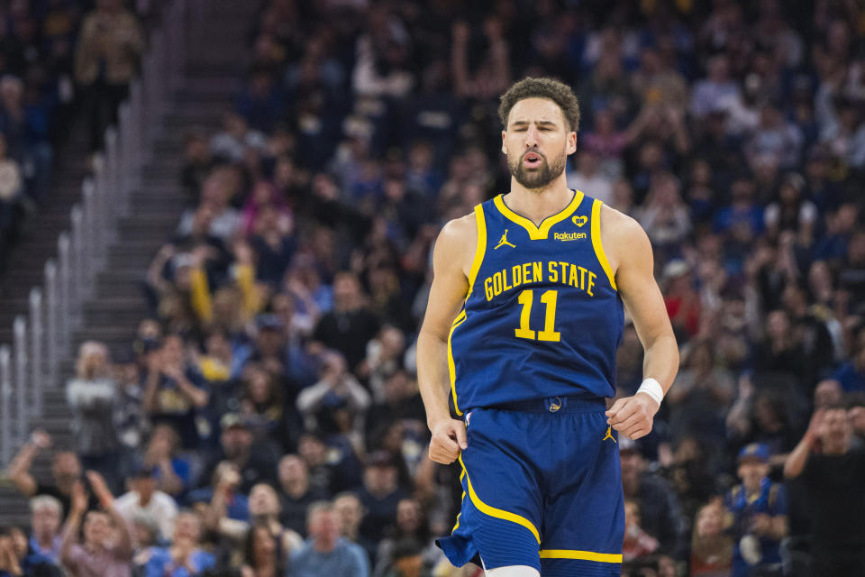 Golden State Warriors guard Klay Thompson (11) reacts to scoring during the first half of an NBA basketball game against the Utah Jazz, Sunday, April 7, 2024, in San Francisco. (AP Photo/Nic Coury)