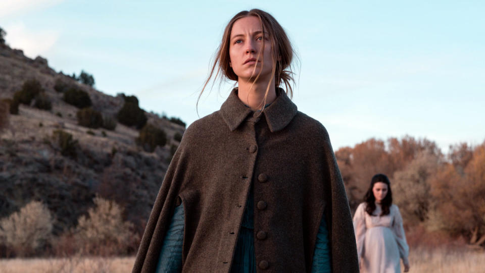 A woman stares ahead in as another woman approachers her from behind in The Wind.