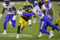 Green Bay Packers' Aaron Jones (33) is tackled by Los Angeles Rams' Jordan Fuller (32) during the first half of an NFL divisional playoff football game Saturday, Jan. 16, 2021, in Green Bay, Wis. (AP Photo/Matt Ludtke)