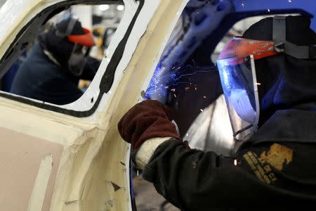 An employee works on a dismantled chasis of a vehicle before armoring it at the garage of Blindajes EPEL company in Mexico City, Mexico April 9, 2018. Picture taken April 9, 2018. REUTERS/Gustavo Graf