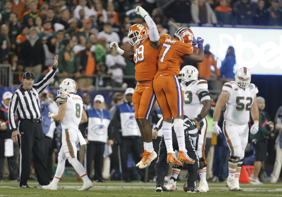 Clemson’s Clelin Ferrell (L) celebrates with Austin Bryant (R) after a play against Miami during the first half of the Atlantic Coast Conference championship NCAA college football game in Charlotte, N.C., Saturday, Dec. 2, 2017. (AP)