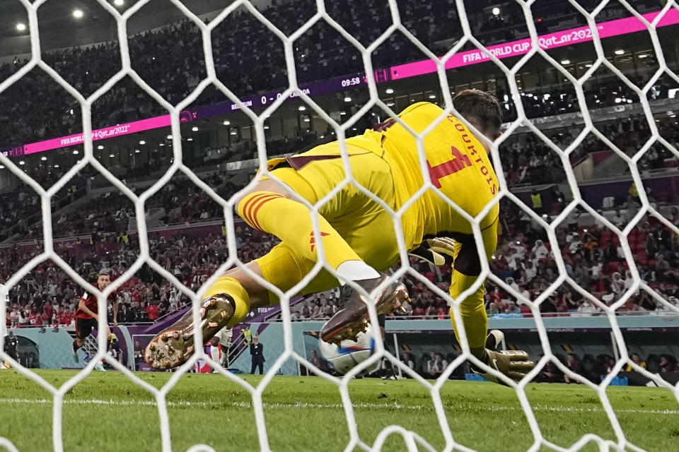 Belgium's goalkeeper Thibaut Courtois saves a penalty by Canada's Alphonso Davies during the World Cup group F soccer match between Belgium and Canada, at the Ahmad Bin Ali Stadium in Doha, Qatar, Wednesday, Nov. 23, 2022. (AP Photo/Darko Bandic)