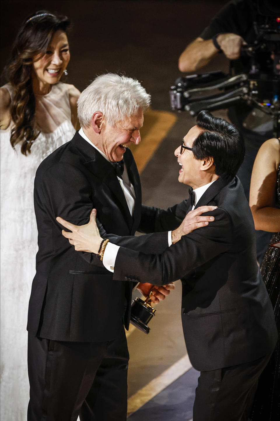 Harrison Ford and Ke Huy Quan embrace during the acceptance for the award for Best Picture for 
