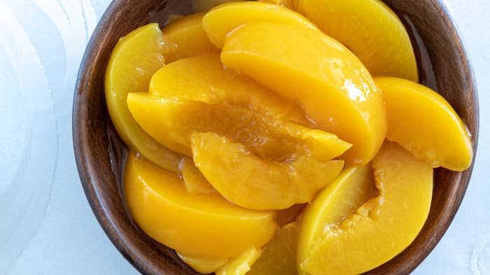 Sliced peaches in a bowl.