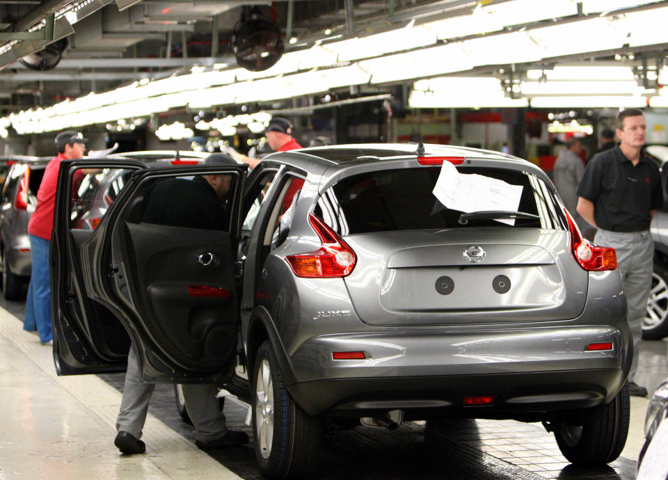 Workers are seen on the assembly line for the Nissan Juke, at the Nissan car factory in Sunderland, England, Thursday, Aug. 26, 2010. (AP Photo/Scott Heppell)