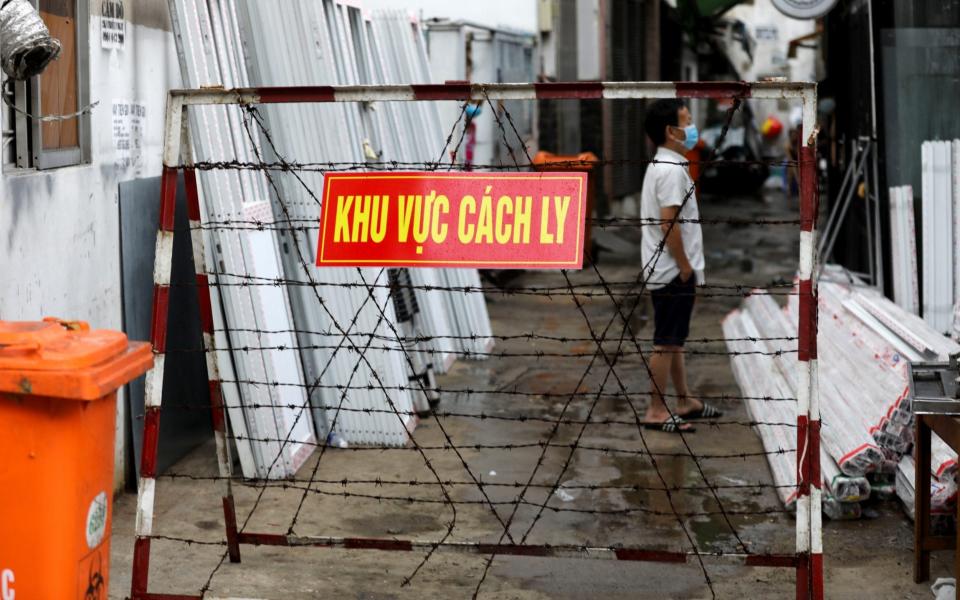 A warning sign is seen outside an area locked in quarantine in Ho Chi Minh city - Reuters