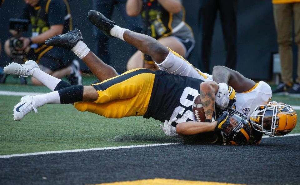 Kent State senior linebacker Khalib Johns tackles <a class="link " href="https://sports.yahoo.com/ncaaf/teams/iowa/" data-i13n="sec:content-canvas;subsec:anchor_text;elm:context_link" data-ylk="slk:Iowa;sec:content-canvas;subsec:anchor_text;elm:context_link;itc:0">Iowa</a> junior wide receiver Nico Ragaini short of the end zone in the fourth quarter at Kinnick Stadium in Iowa City on Saturday, Sept. 18, 2021.