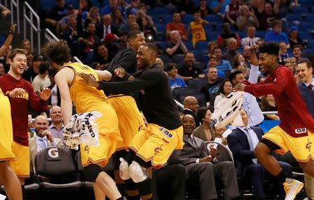 Dec 11, 2015; Orlando, FL, USA; Cleveland Cavaliers forward LeBron James (23), forward Kevin Love (0), and guard Iman Shumpert (4) celebrates as guard James Jones (not pictured) scored his fourth three-pointer in a row against the Orlando Magic during the second half at Amway Center. The Cavaliers won 111-76. Mandatory Credit: Kim Klement-USA TODAY Sports