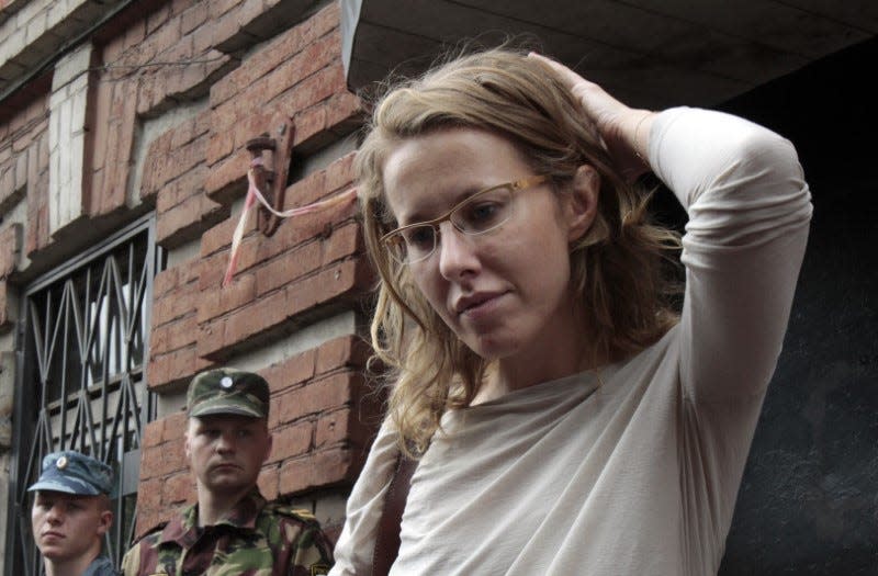 Russian opposition leader and TV host Ksenia Sobchak (R) talks to the media after leaving a building of the Russian Investigative Committee in Moscow June 15, 2012. REUTERS/Sergei Karpukhin  