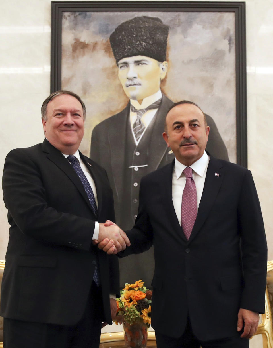 Turkey's Foreign Minister Mevlut Cavusoglu, right, and U.S. Secretary of State Mike Pompeo shake hands before a talks at the Esenboga Airport in Ankara, Turkey, Wednesday, Oct. 17, 2018. Pro-government newspaper Yeni Safak on Wednesday said it had obtained audio recordings of the alleged killing of Saudi writer Jamal Khashoggi inside the Saudi Arabia's consulate in Istanbul on Oct. 2.(Cem Ozdel/Turkish Foreign Ministry via AP)