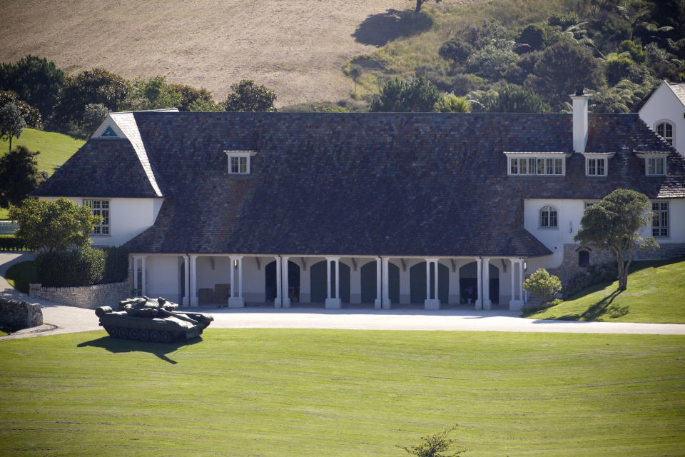 FILE - In this Jan. 25, 2012 file photo an inflatable tank is parked on a hill facing the main gate at Kim Dotcom's house in Coatesville, 30 kilometers (18.6 miles) north west of Auckland, New Zealand, after the house was raided by police and he was arrested on international copyright infringement and money laundering charges. On his way up, he fooled them all: journalists, judges, investors and companies. Then the man who renamed himself Kim Dotcom finally did it. With an eye for get-rich schemes and an ego gone wild, he parlayed his modest computing skills into a mega-empire, becoming the fabulously wealthy computer maverick he had long claimed to be. (AP Photo/Dean Purcell, NZ Herald, File) NEW ZEALAND, AUSTRALIA
