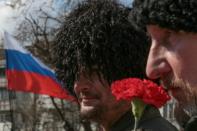 Crimean Cossacks take part in a rally marking the fourth anniversary of Crimea voting to leave Ukraine and join the Russian state in central Simferopol on March 16, 2018