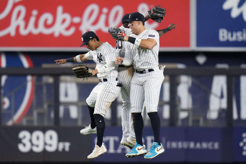 New York Yankees' Aaron Judge, right, celebrates with Oswaldo Cabrera, left, and Estevan Florial after the team's 7-1 win in a baseball game against the Arizona Diamondbacks on Friday, Sept. 22, 2023, in New York. (AP Photo/Frank Franklin II)