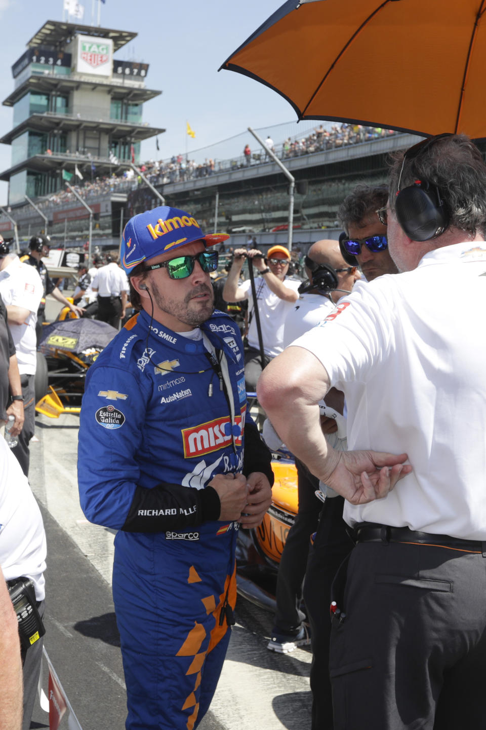 FILE - In this May 18, 2019, file photo, Fernando Alonso, of Spain, talks with his crew as he prepares to qualify for the Indianapolis 500 IndyCar auto race at Indianapolis Motor Speedway in Indianapolis. Alonso will once again attempt to complete motorsports' version of the Triple Crown with a return to the Indianapolis 500 in May with McLaren. (AP Photo/Michael Conroy, File)