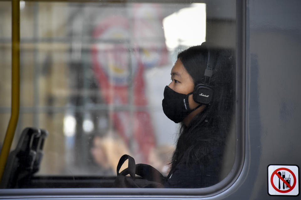 A young woman with face mask is sitting in a tram in Prague, Czech Republic, Thursday, Sept. 17, 2020 The number of new confirmed coronavirus infections have hit a record in the Czech Republic, surpassing 2,000 cases in one day for the first time. (Simanek Vit/CTKvia AP)