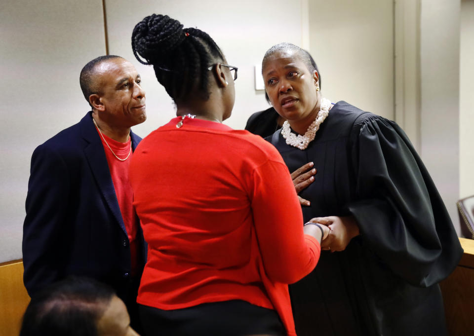 State District Judge Tammy Kemp, right, gives her sympathies to Botham Jean's parents, Allison and Bertrum, left, following the 10-year sentence given to former Dallas Police Officer Amber Guyger for murder, Wednesday, Oct. 2, 2019, in Dallas. Guyger, who said she mistook neighbor Botham Jean's apartment for her own and fatally shot him in his living room, was sentenced to a decade in prison. (Tom Fox/The Dallas Morning News via AP, Pool)