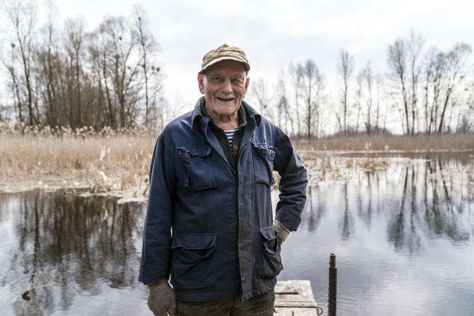 Yevgeny Markevich, a 85-year-old former teacher, smiles smiles during his interview with the Associated Press at the Chernobyl exclusion zone, Ukraine, Wednesday, April 14, 2021. Markevich said "It's a great happiness to live at home, but it's sad that it's not as it used to be." Today, he grows potatoes and cucumbers on his garden plot, which he takes for tests "in order to partially protect myself." The vast and empty Chernobyl Exclusion Zone around the site of the world’s worst nuclear accident is a baleful monument to human mistakes. Yet 35 years after a power plant reactor exploded, Ukrainians also look to it for inspiration, solace and income. (AP Photo/Evgeniy Maloletka)