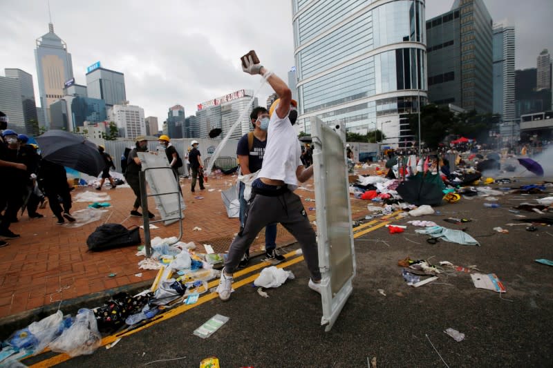 FILE PHOTO: Protester throws a brick during a demonstration against a proposed extradition bill in Hong Kong